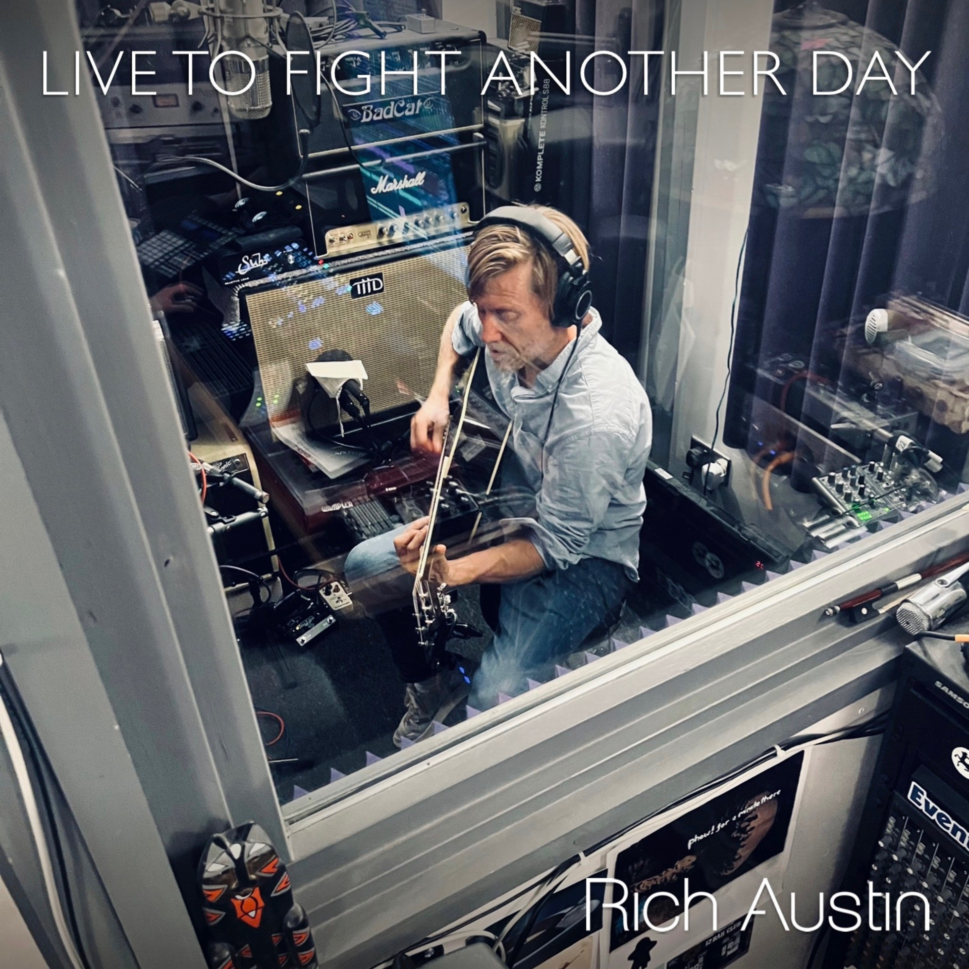 Live To Fight Another Day artwork - Rich Austin playing guitar in a recording booth, seen through the glass