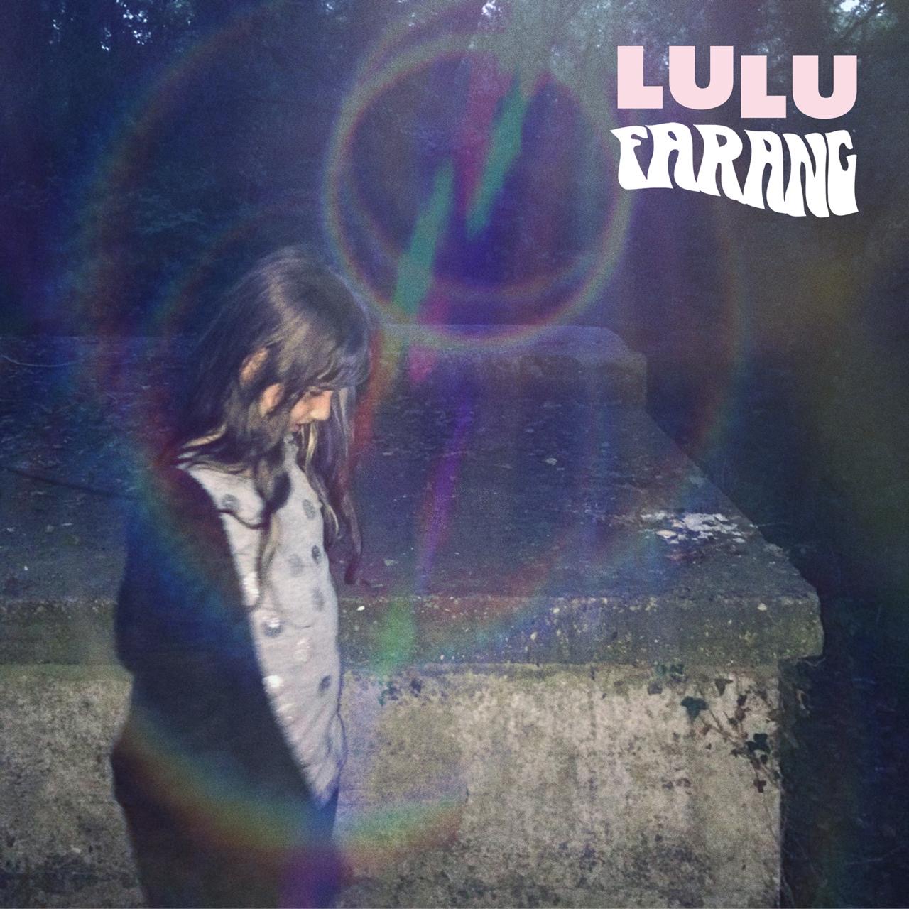 Cover art for Lulu by Farang: a girl with long dark hair looking down beside a stone wall, with a rainbow lens flare and the band name in white lettering